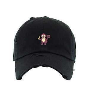 May include: Black distressed baseball cap with a small embroidered image of a monkey holding a banana.