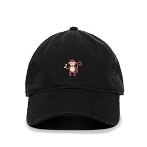May include: A black baseball cap with an embroidered image of a monkey holding a banana.