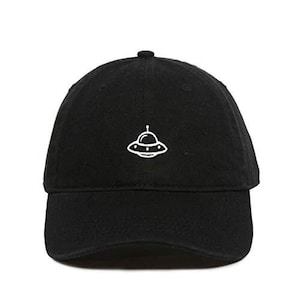 May include: A black baseball cap with a white embroidered UFO design.