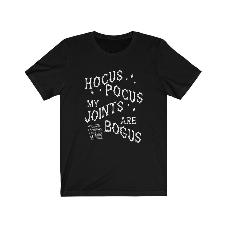 May include: Black t-shirt with white text that reads "Hocus Pocus My Joints Are Bogus" and a small image of a book with the text "Chronic Hames Spell Book".