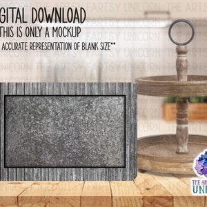 May include: A rustic wooden tiered tray with a gray metal sign. The sign has a distressed wood frame and a textured surface. The tray is perfect for displaying decorative items or serving snacks.