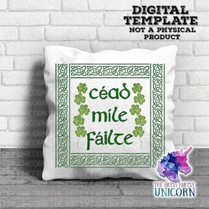 May include: White pillow with a green Celtic knot border and a green shamrock design. The text "céad mile fáilte" is in the center of the pillow.