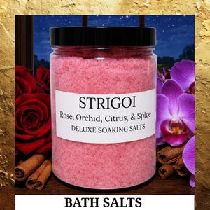 May include: A clear jar filled with pink bath salts, labeled "STRIGOI Rose, Orchid, Citrus, & Spice DELUXE SOAKING SALTS." The jar has a black lid. The background includes red roses, purple orchids, and cinnamon sticks. The words "BATH SALTS" are at the bottom.