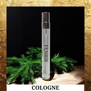 May include: A clear glass cologne bottle with a silver cap, labeled "FENRIR Perfume." The bottle is set against a dark background with green pine branches and the word "COLOGNE" at the bottom.