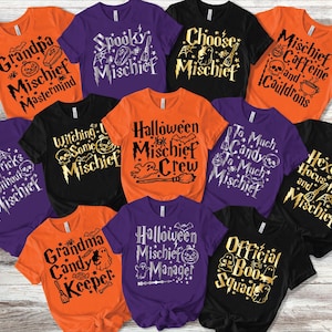 May include: A collection of eleven short-sleeved t-shirts in orange, purple, and black, each featuring unique Halloween-themed graphics and text such as Grandpa Mischief Mastermind, Spooky Mischief, Choose Mischief, Mischief Caffeine and Cauldrons, No Tricks Without Mischief, Witching Some Mischief, Halloween Mischief Crew, To Much Candy To Much Mischief, Hexes Hocus Pocus and Mischief, Grandma Candy Keeper, Halloween Mischief Manager, and Official Boo Squad.