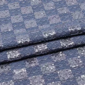 May include: Blue fabric with a checkered pattern made of silver sequins.