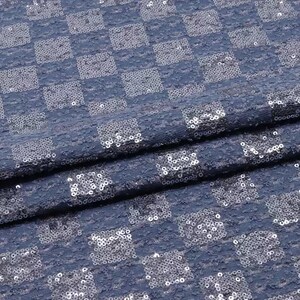 May include: Blue fabric with a checkered pattern made of silver sequins.