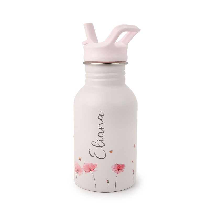 May include: A white stainless steel water bottle with a pink lid and straw. The bottle has a floral design with pink flowers and the name "Eliana" written on it.
