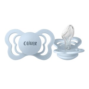 May include: Two light blue pacifiers featuring a butterfly-shaped shield with a central circular plate. One pacifier displays the name Oliver in dark lettering, while the other shows the clear silicone nipple and the embossed brand name BIBS.