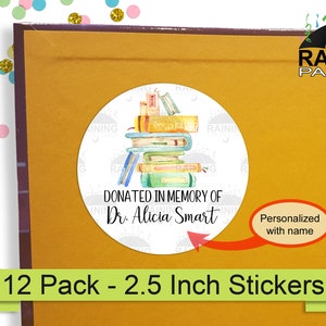 May include: A set of 12, 2.5 inch round stickers featuring a stack of watercolor painted books. The stickers say "Donated in memory of Dr. Alicia Smart" and are personalized with a name.