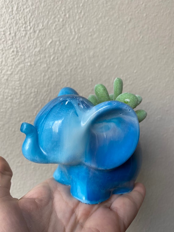 Adorable elephant succulent planter made of cast white and ultramarine blue resin with faux pair of succulents and white small rocks