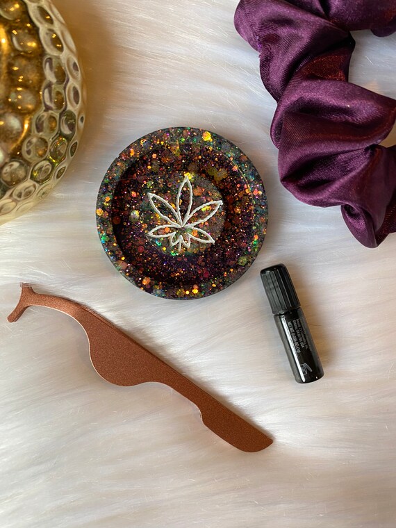 Small weed leaf faux lash eyelash kit with lash glue, tweezers, and matching satin scrunchie in midnight purple w/ green glitter accent