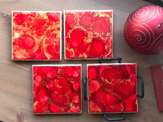 Hand painted 4pc coaster set with metal holder in red, gold, and white ceramic tile with cork backer sealed with resin