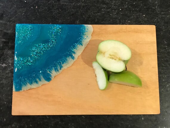 Hand poured in teal and aqua with glitter accent resin cheese/cutting board 12x7.5 white pine stained with organic coffee