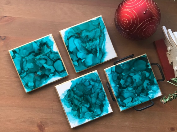 Hand painted 4pc coaster set with metal holder in teal,gold, and white ceramic tile with cork backer sealed with resin