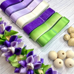 May include: An assortment of craft supplies including rolls of satin ribbon in shades of purple, green, and cream. Also shown are wooden beads and a floral ribbon embellishment.