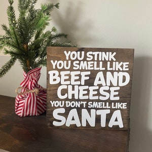 You stink you smell like beef and cheese you don’t smell like Santa, buddy the elf, funny elf movie quote, funny Christmas, holiday sign