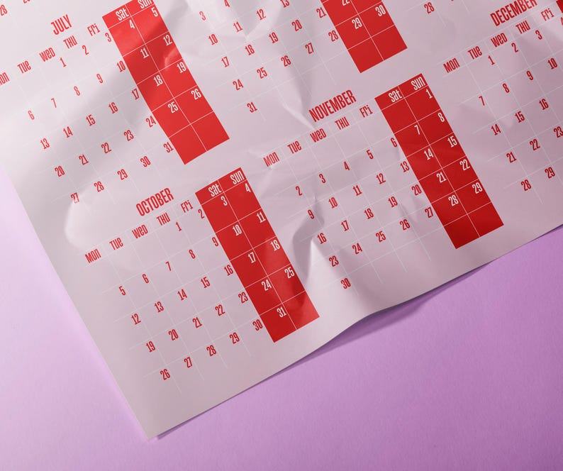 May include: A calendar with red highlighted dates on a white background. Months visible include July, October, November, and December. The calendar is on a purple surface.