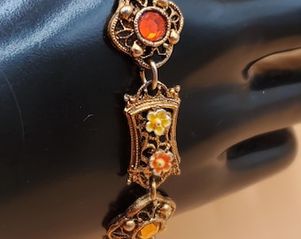 vintage gold tone open work link bracelet with enamel flowers and rhinestone accents