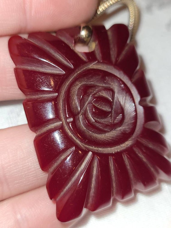 Vintage red carved Bakelite flower pendant - image 1