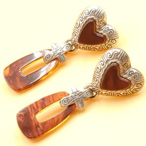 May include: A distressed wooden sign, inscribed with 'Welcome to our home' in white lettering. The sign has a rustic appearance, ideal for a front porch or hallway, and is designed with a simple, welcoming aesthetic.