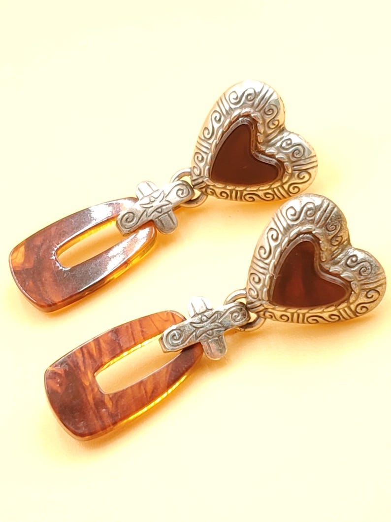 May include: A distressed wooden sign, inscribed with 'Welcome to our home' in white lettering. The sign has a rustic appearance, ideal for a front porch or hallway, and is designed with a simple, welcoming aesthetic.