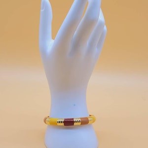 Vintage Joan Rivers gold tone enamel hinged bangle bracelet