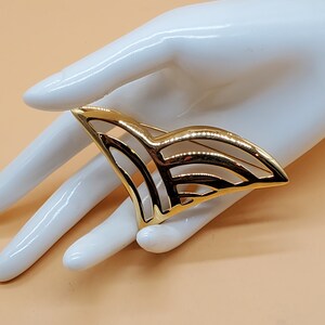 Vintage Monet large gold tone openwork V brooch
