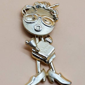 AJC teacher brooch, Signed AJC gold tone articulating head brooch