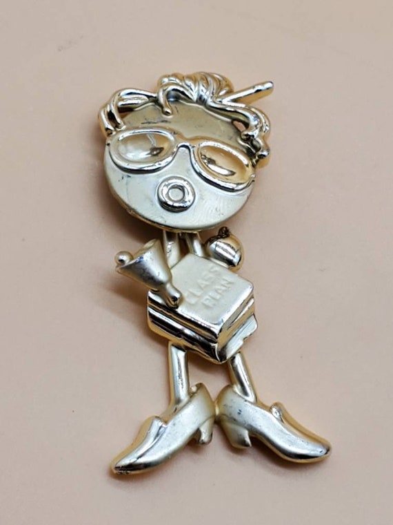 AJC teacher brooch, Signed AJC gold tone articulating head brooch