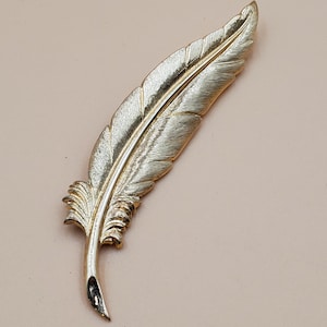 Vintage Monet gold tone feather brooch