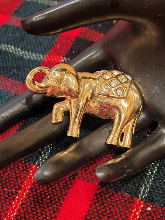 Vintage Monet gold tone elephant brooch with clear