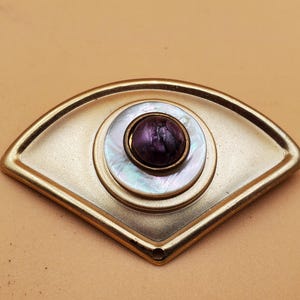 vintage gold tone triangle brooch with faux shell and purple stone center