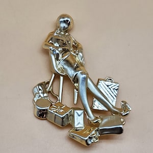 Vintage AJC gold tone exhausted woman brooch
