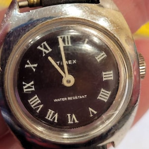 Vintage Timex Water Resistant black face wind up watch, Works