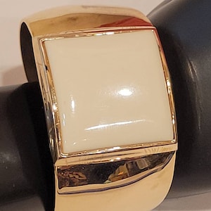 Vintage Avon thick gold tone bracelet with cream lucite plastic top