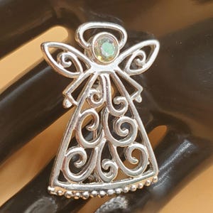 vintage silver tone scrollwork Angel brooch with rhinestone head