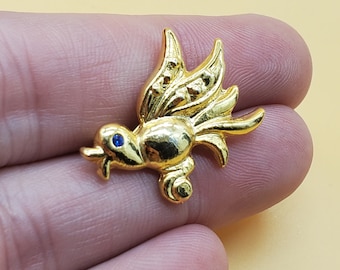 Broche de pájaro vintage en tono dorado con ojo de piedra azul