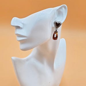 May include: A set of three ceramic mugs with a speckled, matte finish in cream, light brown, and dark brown. Each mug has a simple, minimalist design, ideal for coffee or tea.