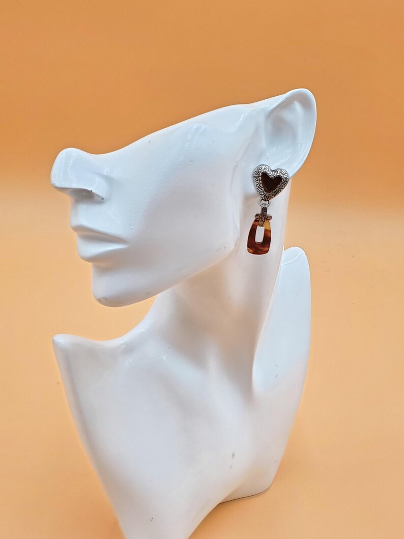 May include: A set of three ceramic mugs with a speckled, matte finish in cream, light brown, and dark brown. Each mug has a simple, minimalist design, ideal for coffee or tea.