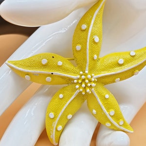 Vintage yellow and white enamel flower brooch