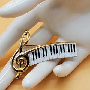 vintage stamped AJC enamel keyboard treble clef brooch