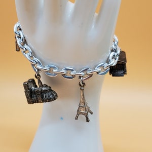 Pulsera vintage con dijes de recuerdo en tono plateado grueso