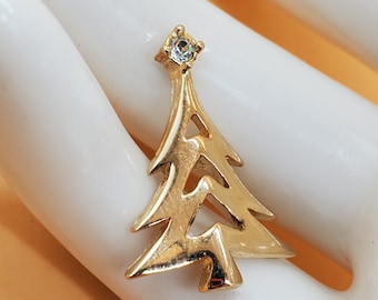 Vintage gold tone Avon Christmas tree pin with rhinestone top