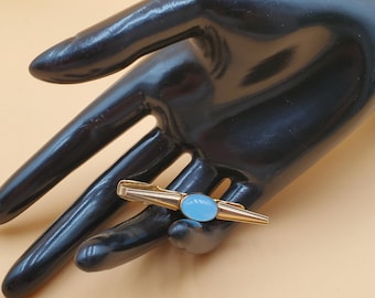 Pinza de corbata vintage MCM Anson tono dorado con piedra azul pálida