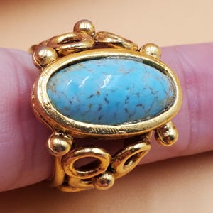 Vintage gold tone fancy openwork adjustable ring with large faux turquoise top