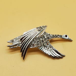 Vintage silver tone clear stone flying duck brooch