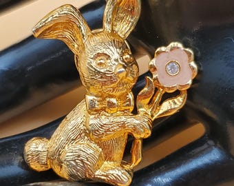 vintage Avon gold tone bunny pin with small enamel rhinestone flower