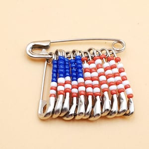 vintage handmade red, white, and blue beaded USA American flag safety pin brooch