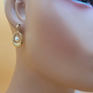 Vintage 14k earrings with dangling pearl centers